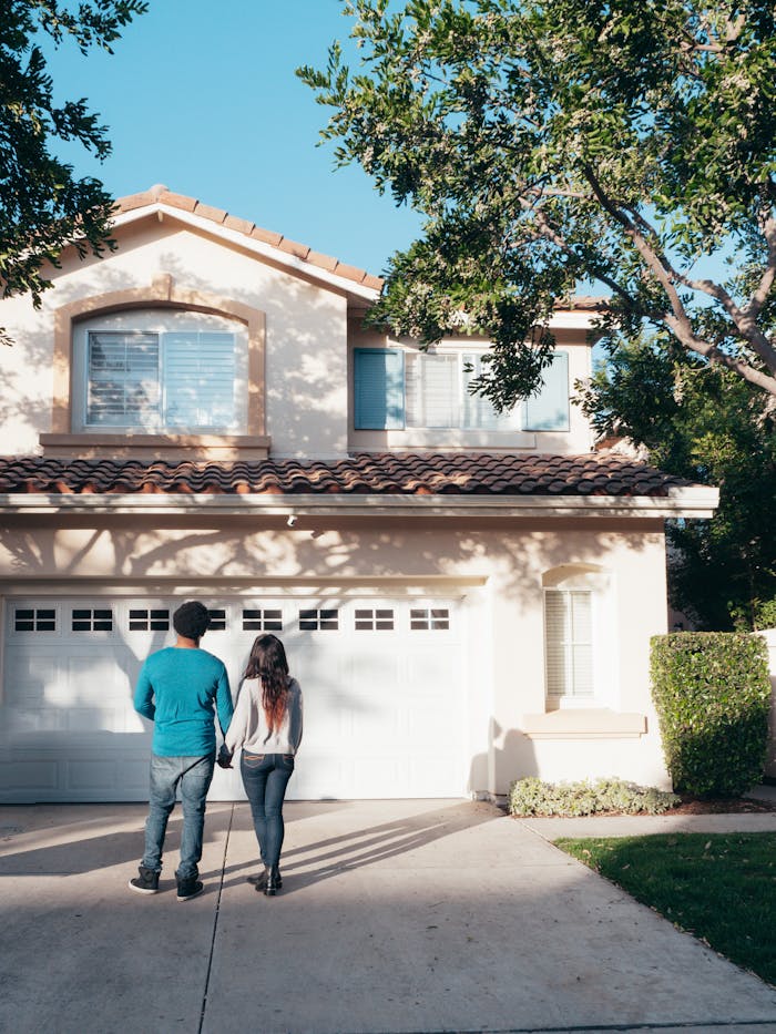 services-img A couple stands hand in hand, admiring their new house and life ahead.