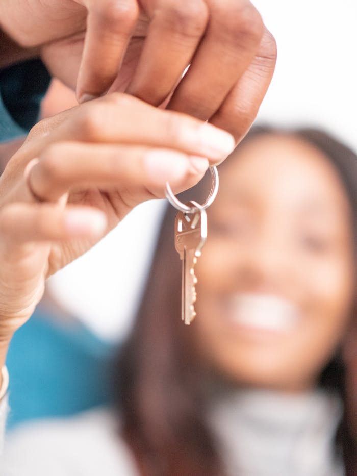 gallery-2 Joyful moment of new homeowners receiving keys to their new house, symbolizing hope and new beginnings.